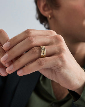 Model wearing Stephen Webster Thorn Inscription Band in 18 k yellow gold