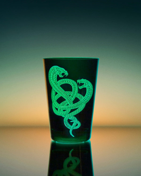 Stephen Webster x Artěl Master Serpent in Racer Green Crystal Tumbler on Artistic Background Highlighting Handcrafted Crystal & Gold Detail