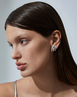 Caged Aquamarine Earrings worn on ear, luxury fine jewellery with aquamarine gemstones