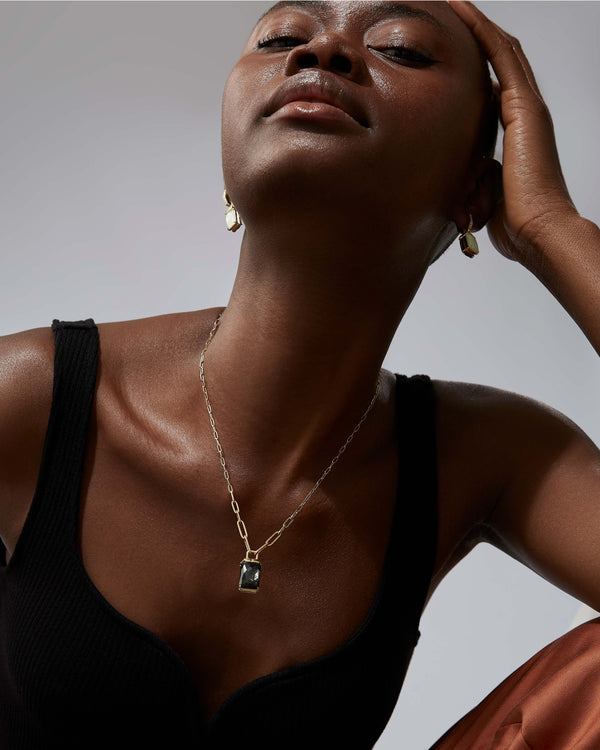 Chrysolemon Obsidian Crystal Haze and diamond twister pendant worn on the neck in 18ct yellow gold