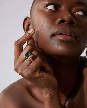 Close-up of obsidian Crystal Haze gemstone and diamond details on 18ct yellow gold tablet twister ring