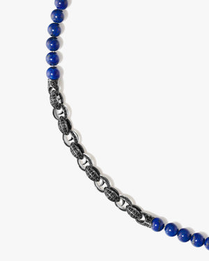 Close-up of blue lapis gemstone beads and black sapphire pavé Thorn motif on Stephen Webster Thorn Beaded Necklace