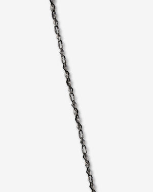 Close-up of the thorn dagger motif and polished black rhodium-plated sterling silver finish on Stephen Webster Thorn Dagger Pendant