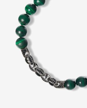 Close-up of green malachite beads and black sapphire pavé on sterling silver Thorn motif of Stephen Webster’s beaded bracelet