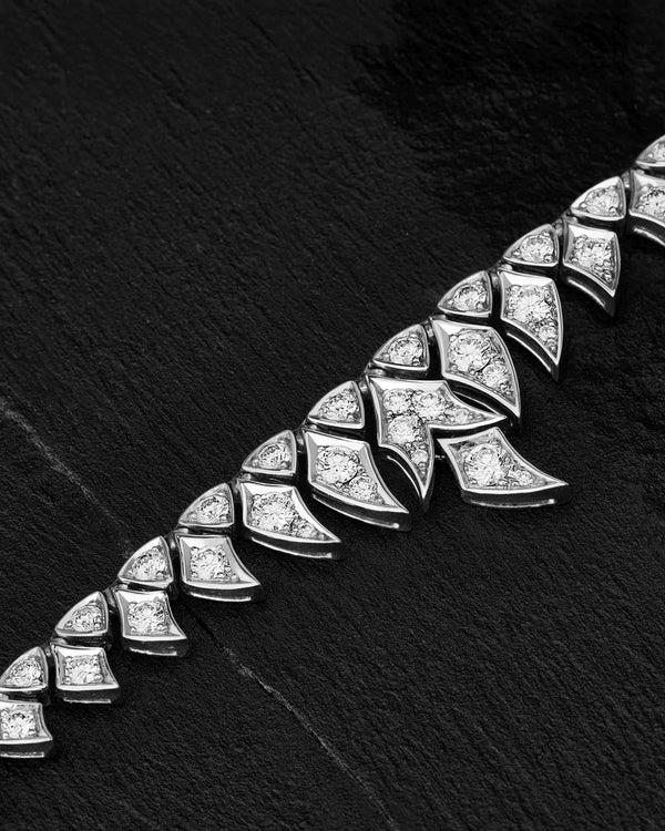 Close-up of white diamond pavé and feather-inspired detailing on White Gold Tail Feather Collar