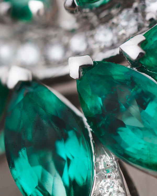 Close-up of marquise emeralds and white diamond pavé detailing on White Gold Plumage Earrings