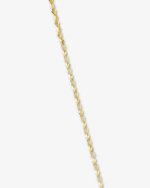 Detail close-up of the yellow gold Thorn Dagger motif and polished finish on Stephen Webster pendant