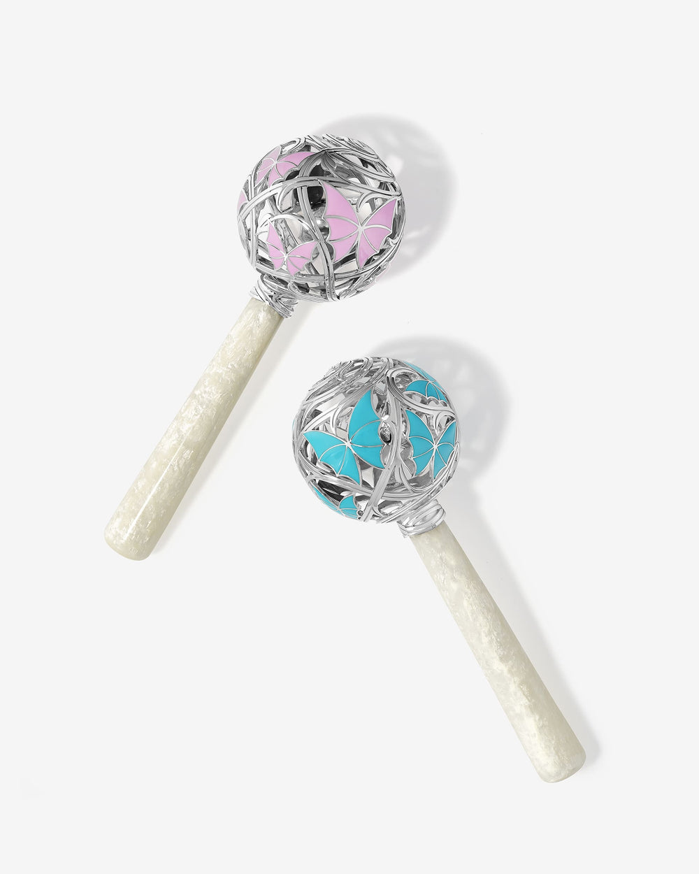 'Cry By Night' Rattle' in sterling silver pink enamel butterfly design, thorn-inspired openwork and mother-of-pearl handle.