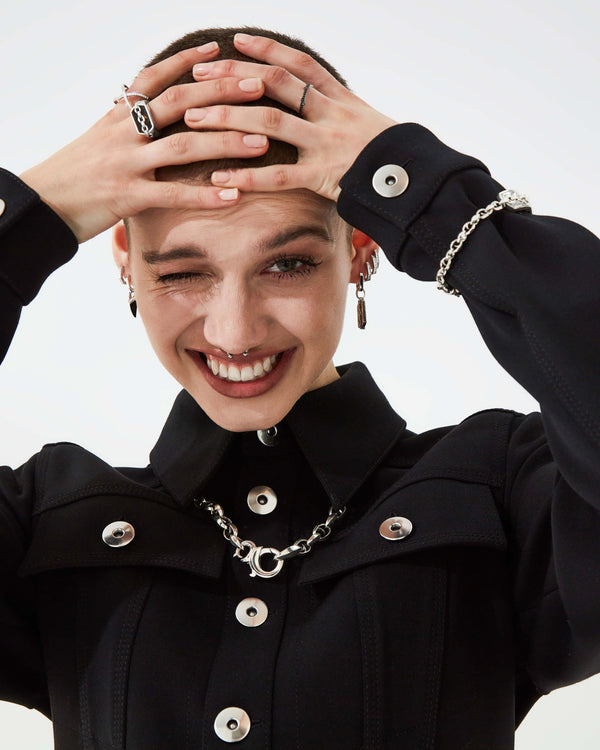 Editorial style image featuring Stephen Webster Inline Tiger Iron Pinky Ring worn by male model in a fashion look