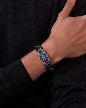 Model wearing Stephen Webster Fish Brawler clasp in sterling silver with central aquamarine with blue enamel and mother of pearl back plate