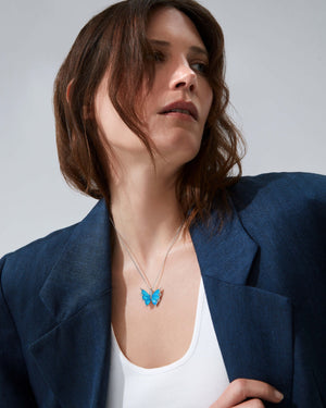 Model wearing Fly By Night butterfly Black Opalescent Crystal Haze pendant necklace in 18k white gold