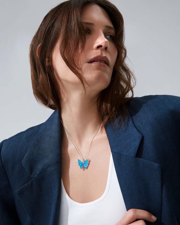 Model wearing Fly By Night butterfly Black Opalescent Crystal Haze pendant necklace in 18k white gold