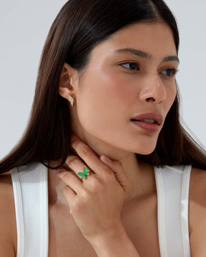 Model wearing Fly By Night mini butterfly cocktail ring in 18k yellow gold with green gemstones