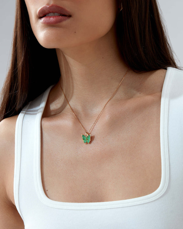 Model wearing Fly By Night mini butterfly Crystal Haze pendant necklace in 18k yellow gold with light green agate