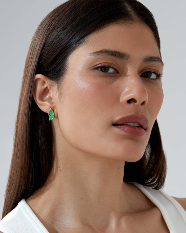 Model wearing Fly By Night butterfly earrings in 18k yellow gold with precious green gemstones