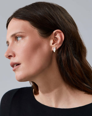 Model wearing Fly By Night butterfly earrings in 18k yellow gold with precious gemstones