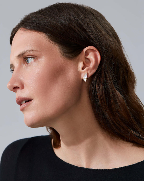 Model wearing Fly By Night butterfly earrings in 18k yellow gold with precious gemstones