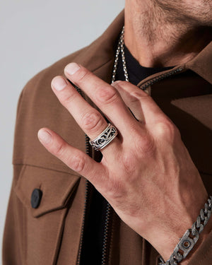 Full hand shot of male model wearing Stephen Webster Thorn Carved Rotating Ring showing fit and style