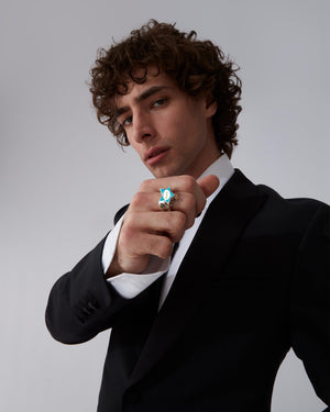 Male model wearing Stephen Webster × Machine Gun Kelly Gossip Ring — silver ring with turquoise enamel star