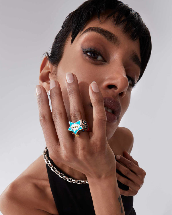 Female model wearing Stephen Webster × Machine Gun Kelly Gossip Ring — silver ring with turquoise enamel star