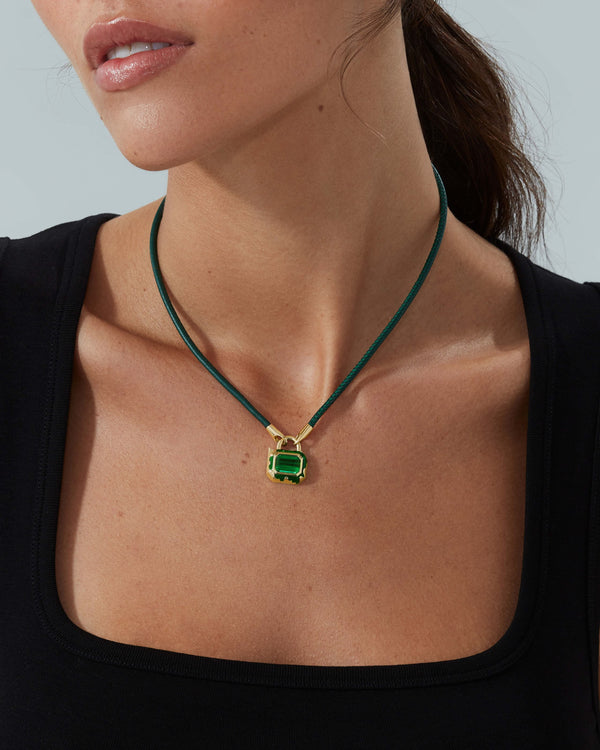 Model wearing a Green Tourmaline Interlock leather pendant in 18ct Yellow Gold by Stephen Webster