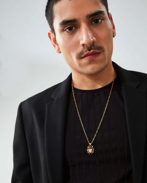 “Model wearing Stephen Webster Jitterbug Toro Beetle pendant — 18 ct yellow-gold insect pendant with diamond pavé and spinel detail”