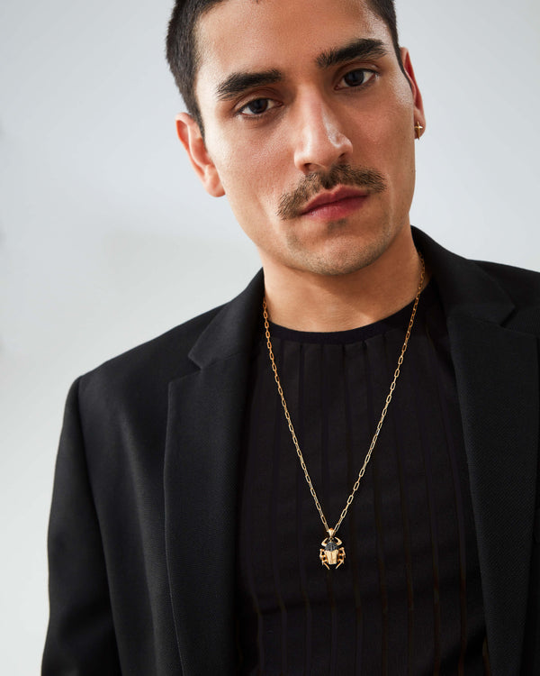 “Model wearing Stephen Webster Jitterbug Toro Beetle pendant — 18 ct yellow-gold insect pendant with diamond pavé and spinel detail”