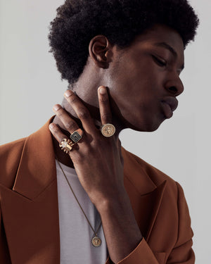 Model wearing Stephen Webster Jitterbug Toro Beetle Ring with other rings — 18 ct yellow-gold ring with beetle motif, ruby eyes and diamonds