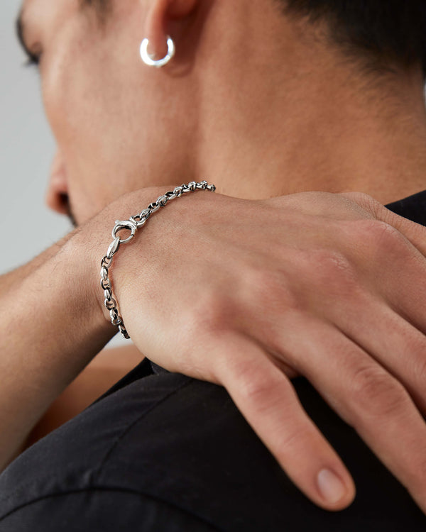 Macro close-up of Stephen Webster Thorn Classic 7 mm link silver bracelet on skin, showing texture and finish