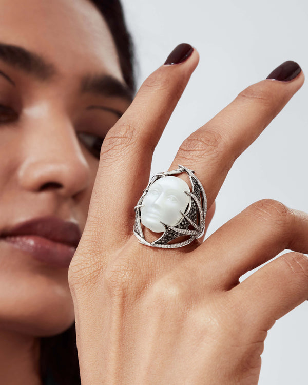 Close-up detail of carved moonstone face and pavé grey & white diamonds on Making Waves ring