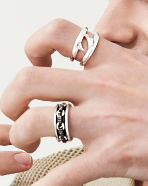 Male model wearing Stephen Webster Double Thorn Sterling Silver Band styled with other men’s jewellery pieces