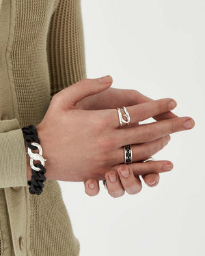 Male model wearing Stephen Webster Thorn Addiction silver clasp layered with other men’s jewellery pieces