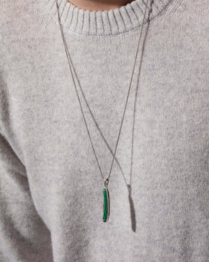 Man wearing Stephen Webster silver Switchblade pendant with green malachite — luxury jewellery styling