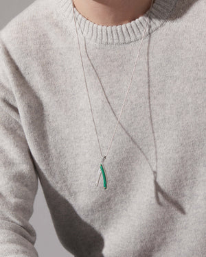 Man wearing Stephen Webster silver Switchblade pendant with green malachite — luxury jewellery styling