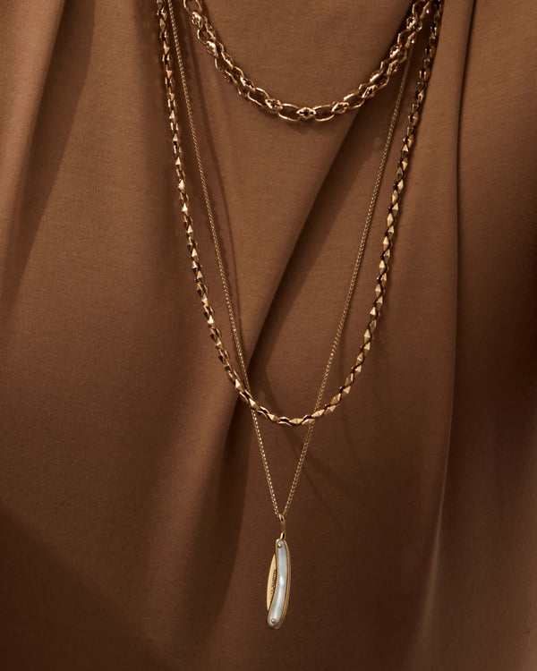 Men’s necklace featuring Stephen Webster yellow gold Switchblade pendant with white mother-of-pearl inlay — luxury fine jewellery