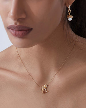 Model close up wearing Stephen Webster Y is for Yellowfin Tuna initial necklace in 18ct yellow gold with diamonds, personalised luxury jewellery gift for her