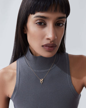 Model wearing Stephen Webster H is for Hammerhead Shark initial necklace in 18ct yellow gold with diamonds, personalised luxury gift for her