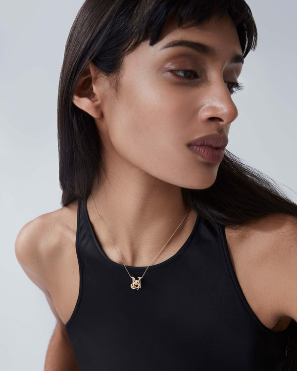 Model wearing Stephen Webster N is for Newt initial necklace in 18ct yellow gold with diamonds, personalised luxury jewellery gift for her