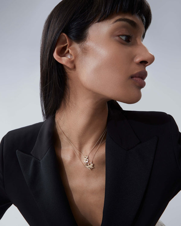 Model wearing Stephen Webster S is for Seahorse initial necklace in 18ct yellow gold with diamonds, personalised luxury jewellery gift for her