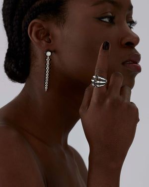 Model wearing Stephen Webster Enamel Bombé Ring in 18ct white gold with white diamonds and black enamel, styled as a luxury jewellery gift