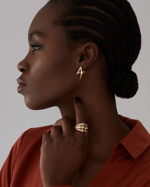 Model wearing Stephen Webster Shattered Bombé Ring in 18ct yellow gold with white diamonds, styled as a luxury jewellery gift for her