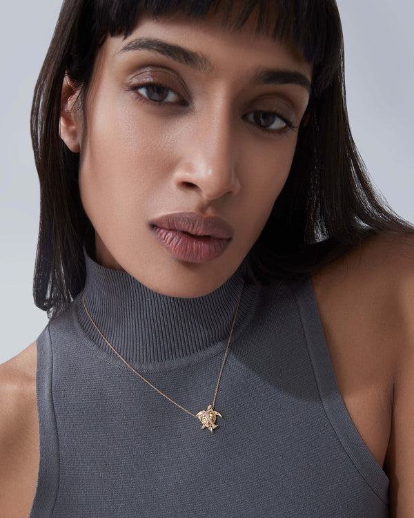 Model wearing Stephen Webster T is for Turtle initial necklace in 18ct yellow gold with diamonds, personalised luxury jewellery gift for her