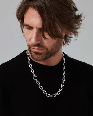 Lifestyle image of model wearing Stephen Webster Thorn Entwined 9 mm link sterling silver chain with modern menswear