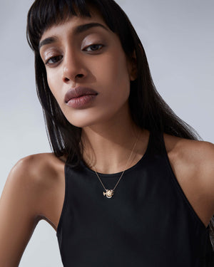 Model wearing Stephen Webster U is for Unicorn Fish initial necklace in 18ct yellow gold with diamonds, personalised luxury jewellery gift for her