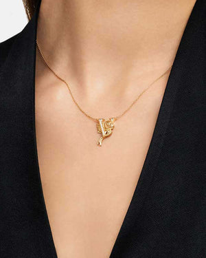 Model wearing Stephen Webster V is for Viperfish initial necklace in 18ct yellow gold with diamonds, personalised luxury jewellery gift for her