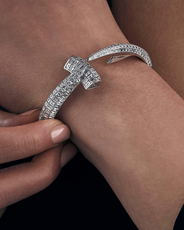Close-up wrist shot of Stephen Webster Hammerhead Bangle in 18ct white gold with white diamonds, elegant jewellery detail