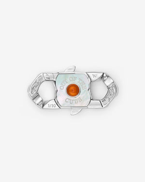 Stephen Webster Out of the Cube clasp in sterling silver with central fire opal, green & orange enamel and mother of pearl back plate — back view