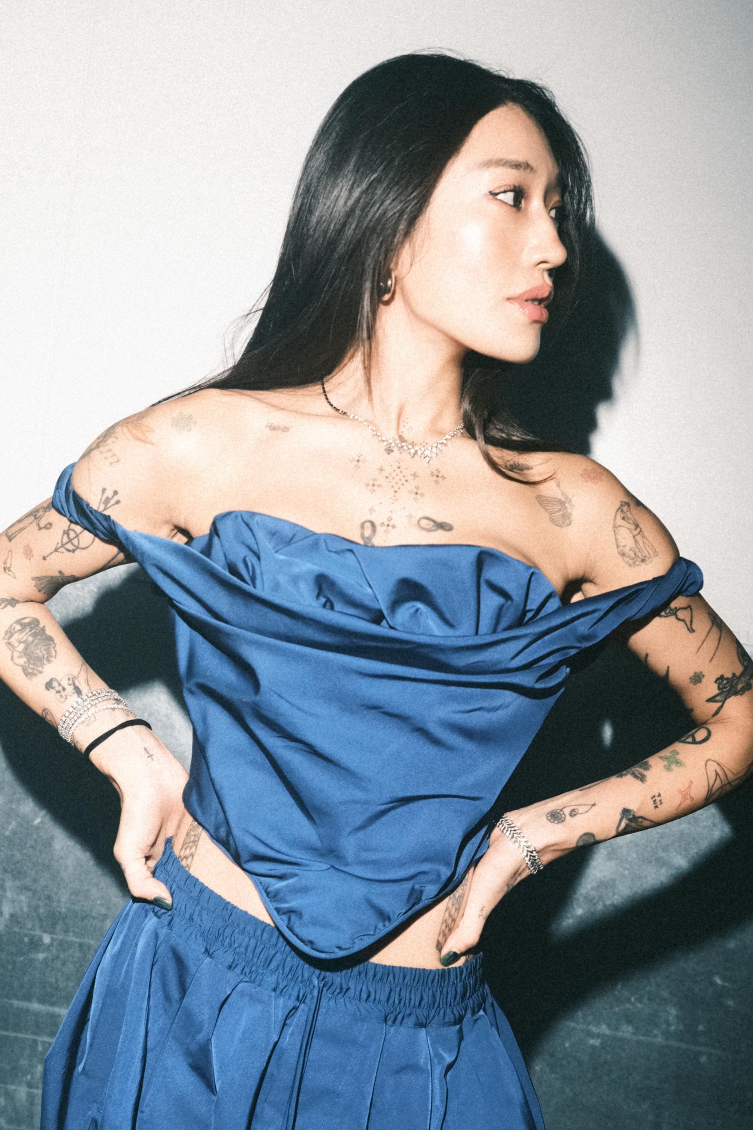 Peggy Gou wearing Stephen Webster Tail Feather Collar and Open Plume Slimline Linked Bracelet