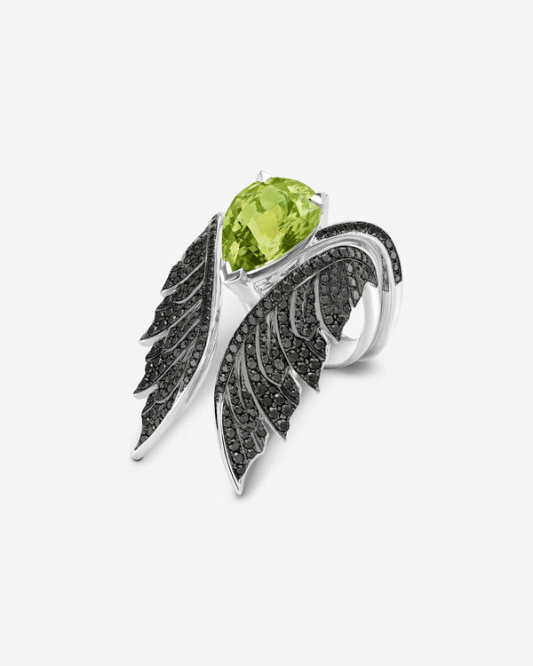 Angled view of peridot pear inner cocktail ring in 18ct white gold with diamond pavé detailing