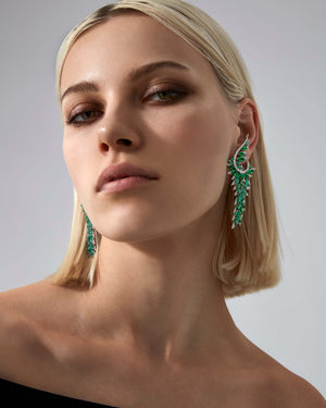 Plumage Long Earrings worn on ear, highlighting emerald and pavé sparkle